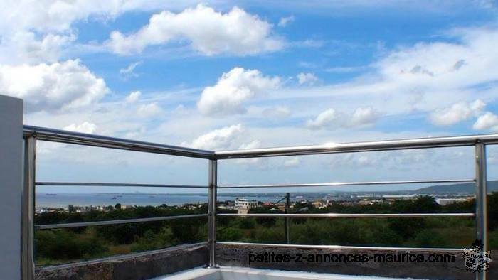 FOR SALE MODERN AND LUXURY VILLA IN POINTE AUX SABLES, OFFERING A PANORAMIC SEA AND MOUNTAIN VIEW.